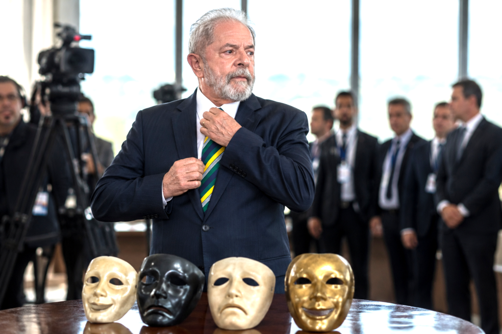 Political leader standing before theatrical masks symbolizing ideological transformation and strategic repositioning.