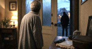 Older person facing a stronger intruder from inside a home, illustrating physical vulnerability and the right to self-defence
