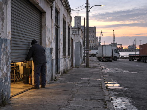 Small business owner closing a workshop in Montevideo amid signs of economic stagnation.