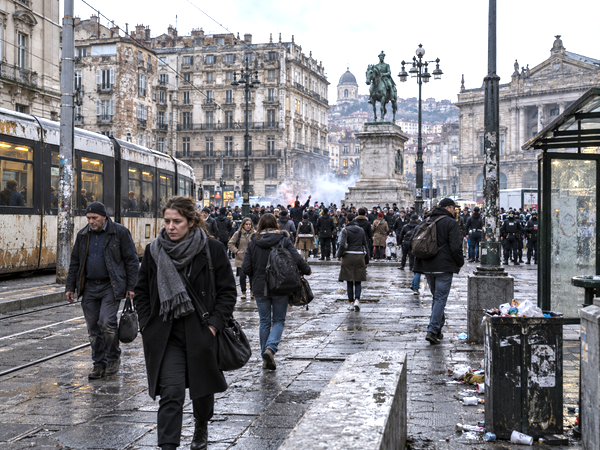 European urban scene reflecting economic strain, social protest and public-service deterioration.